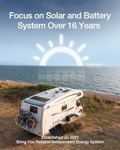 Camper with solar panels by the sea with text about solar and battery system experience.